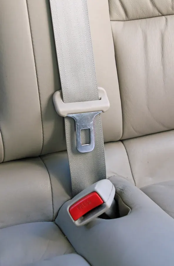 Three-point seat belt fitted to a vehicle seat showing lap and diagonal sections